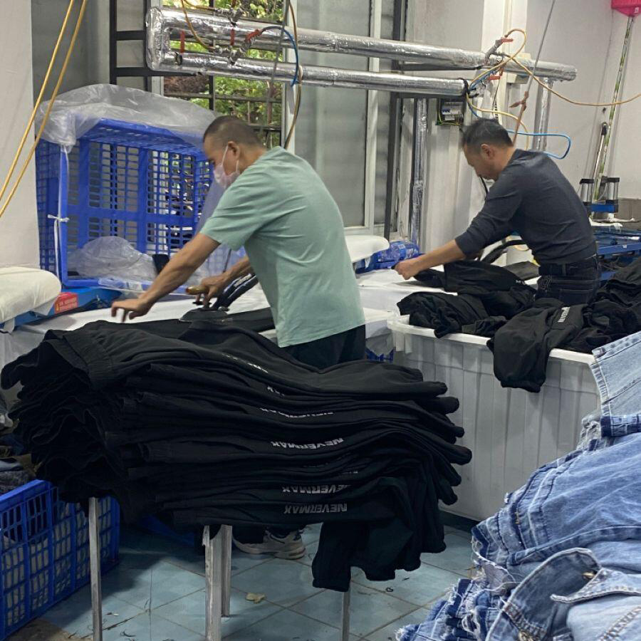 Custom Clothing Manufacturer worker garment pressing finished apparel