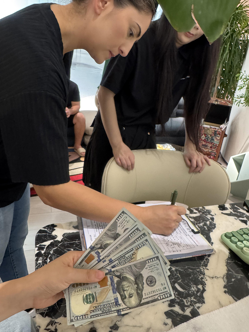 Custom Clothing Manufacturer wholesale clients inspecting garment factory