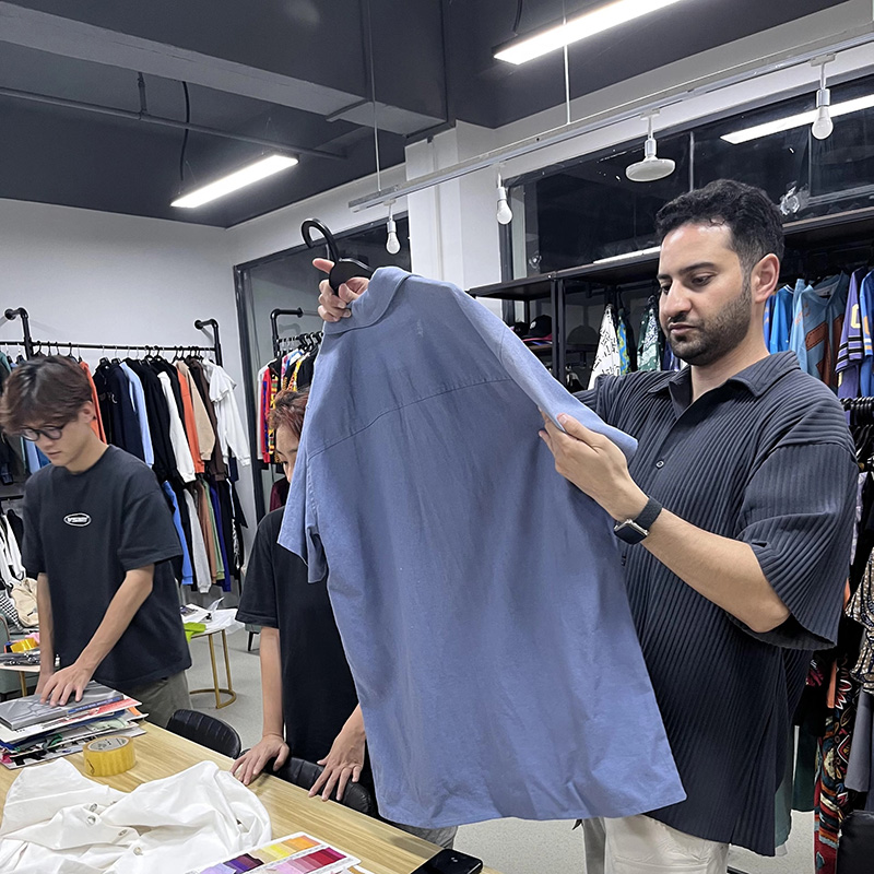 Custom Clothing Manufacturer global clients touring apparel production facility